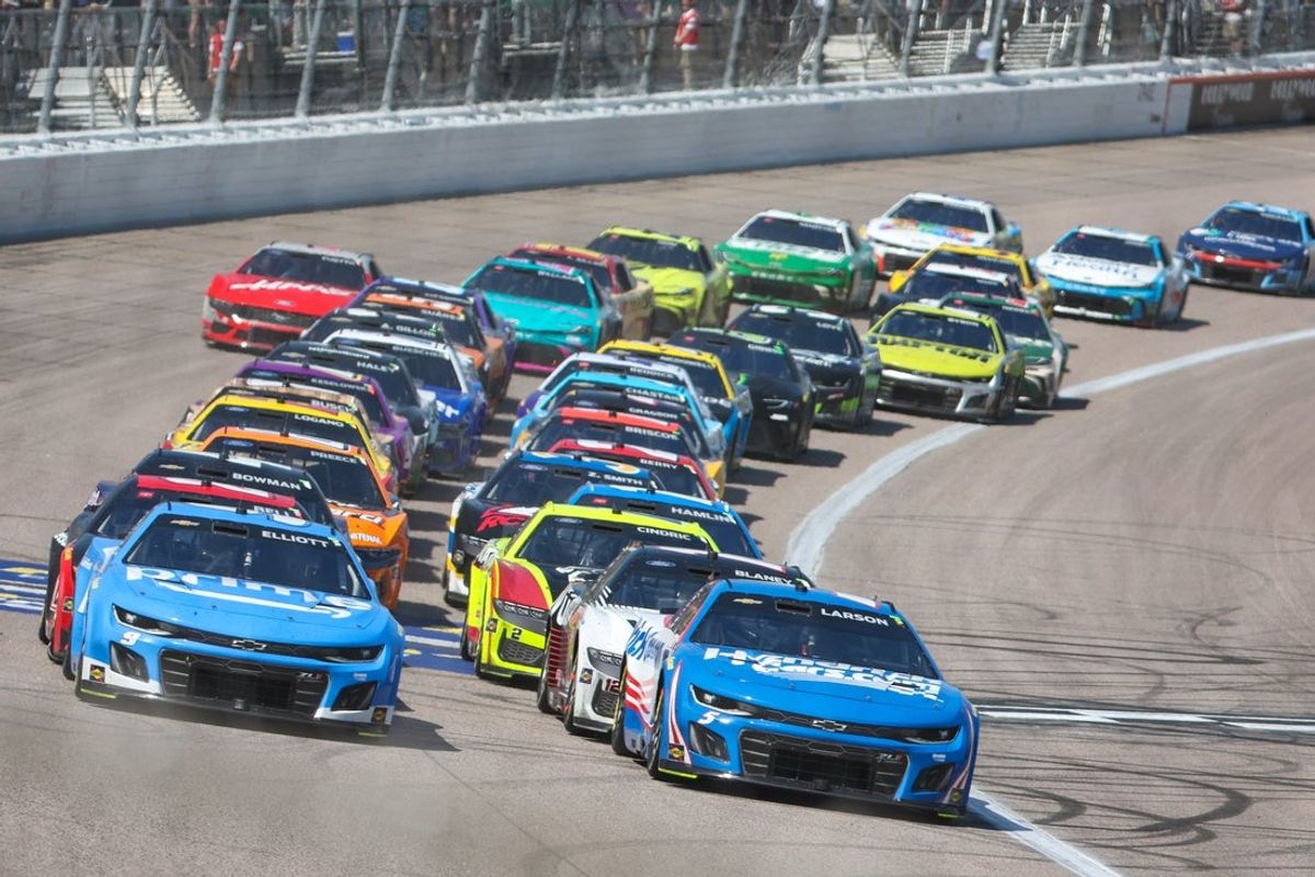 May 11, 2025; Kansas City, Kansas, USA; NASCAR Cup Series drivers Kyle Larson (5) and Chase Elliott (9) lead the field during a restart at the AdventHealth 400 at Kansas Speedway. Mandatory Credit: Scott Sewell-Imagn Images
