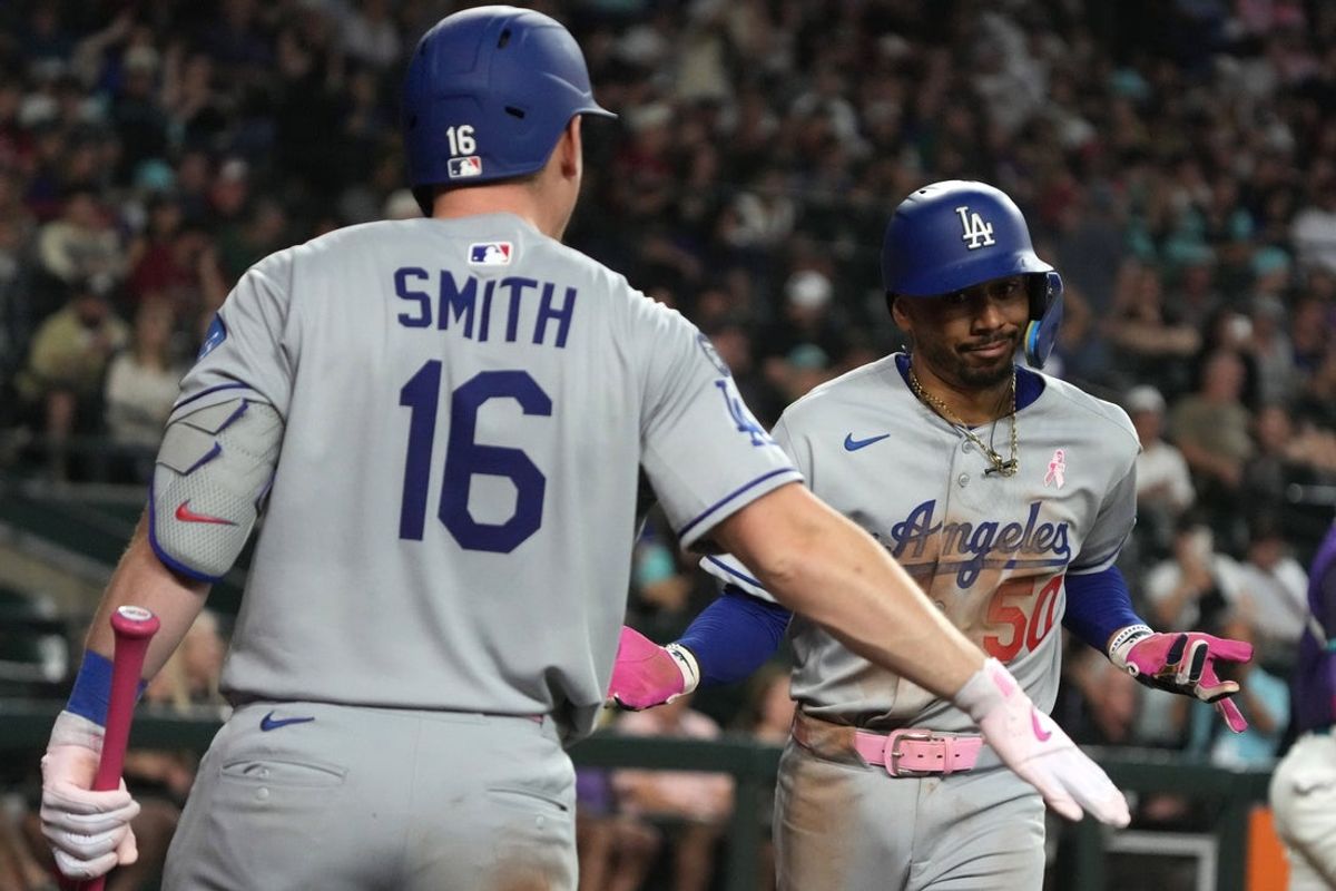 May 11, 2025; Phoenix, Arizona, USA; Los Angeles Dodgers shortstop Mookie Betts (50) celebrates with catcher Will Smith (16) after hitting a solo home run against the Arizona Diamondbacks in the ninth inning at Chase Field. Mandatory Credit: Rick Scuteri-Imagn Images