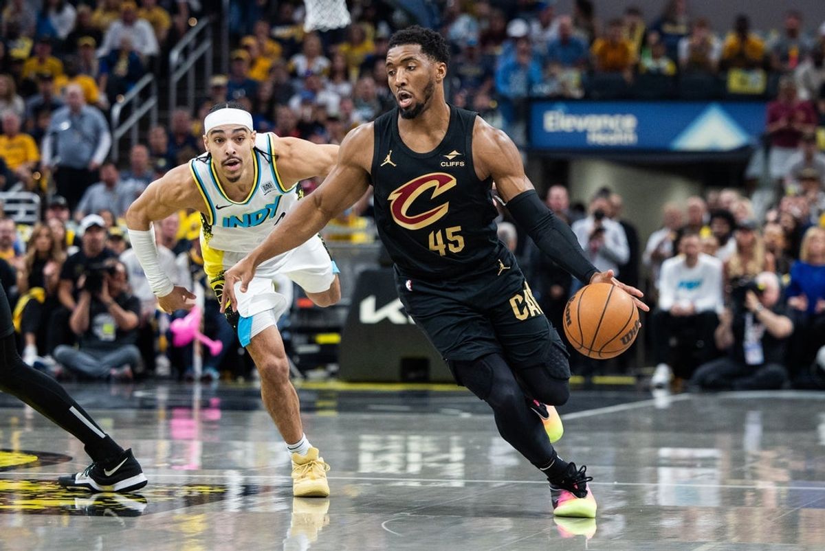 May 11, 2025; Indianapolis, Indiana, USA; Cleveland Cavaliers guard Donovan Mitchell (45) dribbles the ball while Indiana Pacers guard Andrew Nembhard (2) defends during game four of the second round for the 2025 NBA Playoffs at Gainbridge Fieldhouse. Mandatory Credit: Trevor Ruszkowski-Imagn Images