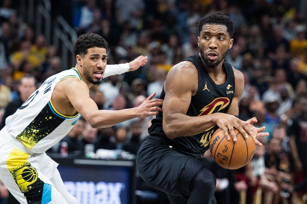 May 11, 2025; Indianapolis, Indiana, USA; Cleveland Cavaliers guard Donovan Mitchell (45) dribbles the ball while Indiana Pacers guard Tyrese Haliburton (0) defends during game four of the second round for the 2025 NBA Playoffs at Gainbridge Fieldhouse. Mandatory Credit: Trevor Ruszkowski-Imagn Images