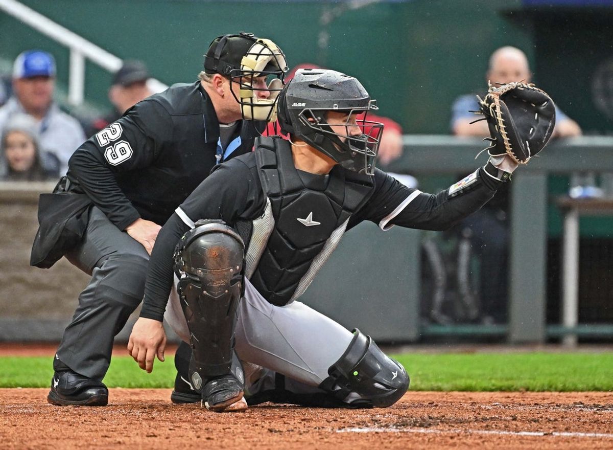 May 7, 2025; Kansas City, Missouri, USA;  Chicago White Sox catcher Matt Thaiss (29) gets set behind home plate with home plate umpire Sean Barber (29) in the third inning against the Kansas City Royals at Kauffman Stadium. Mandatory Credit: Peter Aiken-Imagn Images