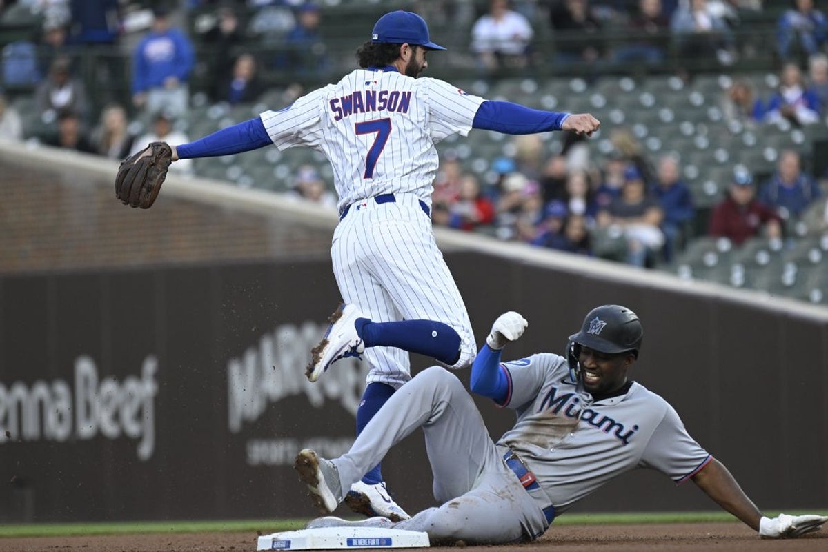 May 12, 2025; Chicago, Illinois, USA;  Chicago Cubs shortstop Dansby Swanson (7) throws to first for a double play after forcing Miami Marlins outfielder Jesús Sánchez (7) out during the first inning at Wrigley Field. Mandatory Credit: Matt Marton-Imagn Images