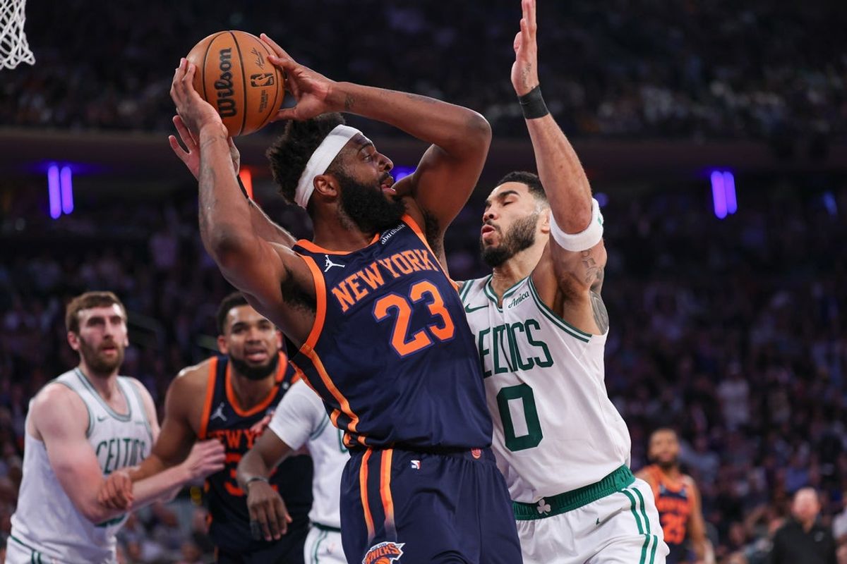 May 12, 2025; New York, New York, USA; New York Knicks center Mitchell Robinson (23) looks to pass after a rebound as Boston Celtics forward Jayson Tatum (0) defends in the first half during game four of the second round for the 2025 NBA Playoffs at Madison Square Garden. Mandatory Credit: Vincent Carchietta-Imagn Images