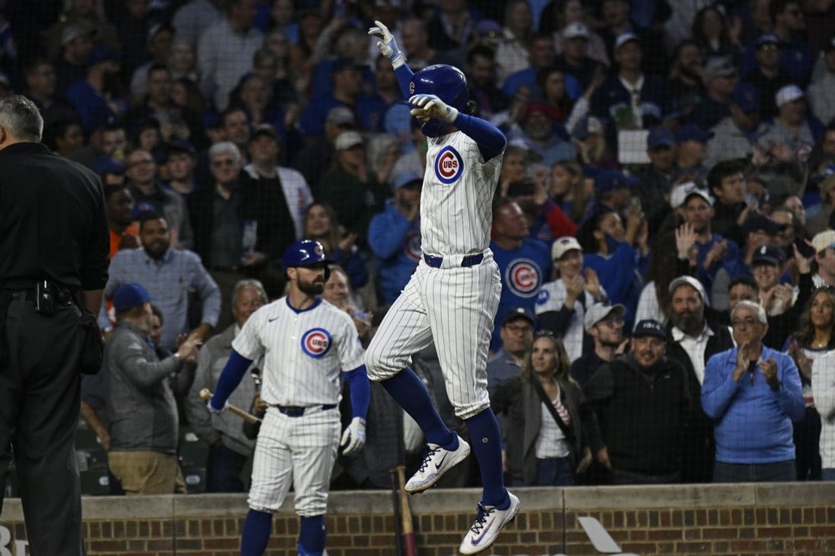 May 12, 2025; Chicago, Illinois, USA;  Chicago Cubs shortstop Dansby Swanson (7) jumps at home after he  hit a two run home run against the Miami Marlins during the fifth inning at Wrigley Field. Mandatory Credit: Matt Marton-Imagn Images