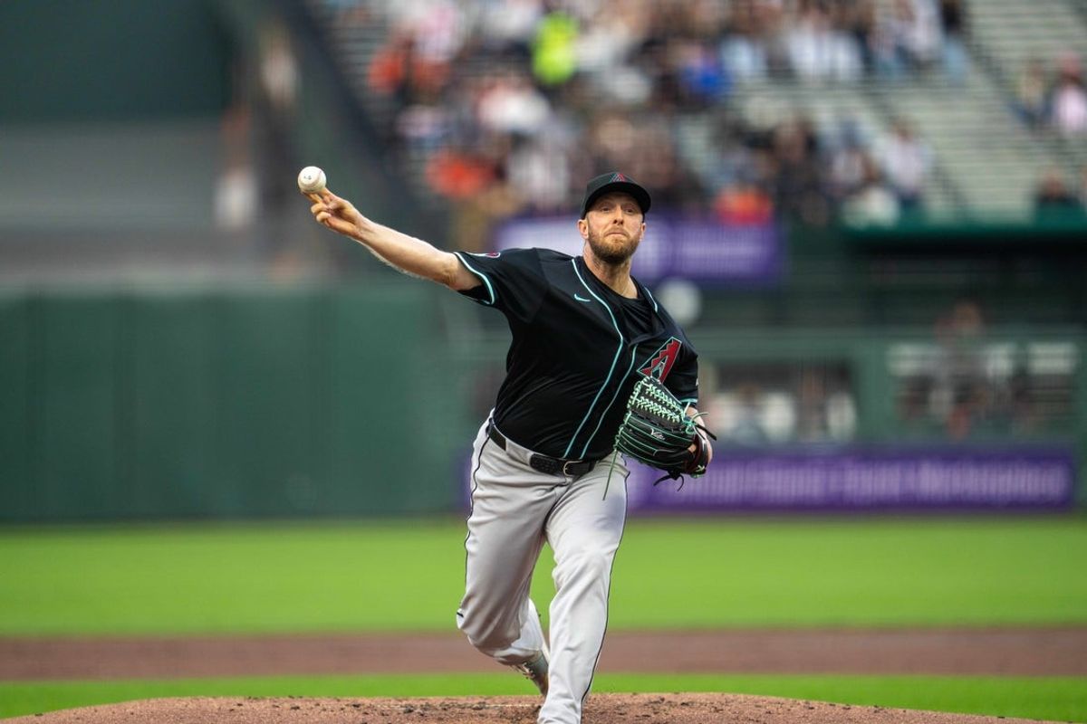 May 12, 2025; San Francisco, California, USA; Arizona Diamondbacks starting pitcher Merrill Kelly (29) delivers a pitch against the San Francisco Giants during the first inning at Oracle Park. Mandatory Credit: Neville E. Guard-Imagn Images