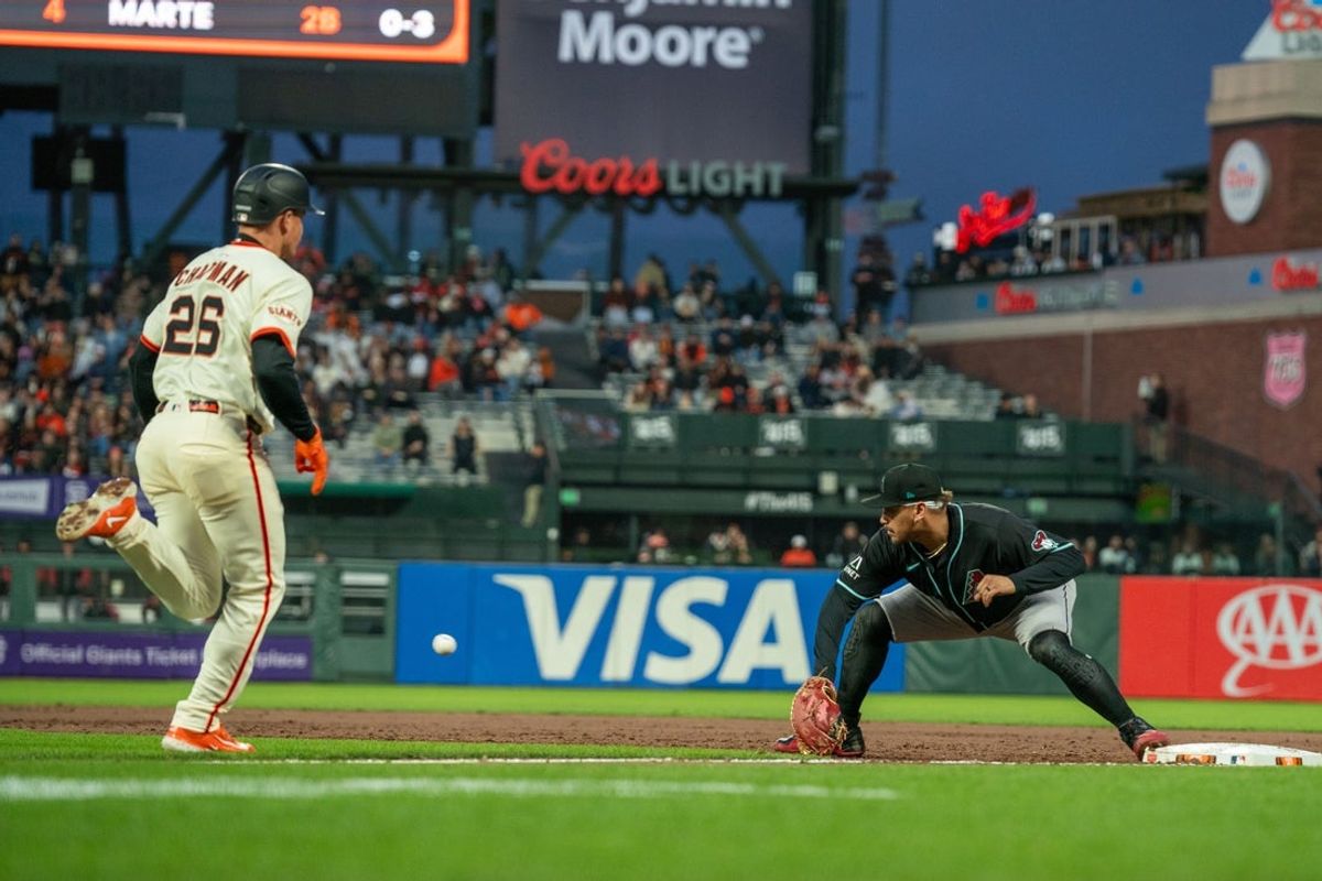 May 12, 2025; San Francisco, California, USA; San Francisco Giants third baseman Matt Chapman (26) is forced out bey Arizona Diamondbacks first baseman Josh Naylor (22) during the sixth inning at Oracle Park. Mandatory Credit: Neville E. Guard-Imagn Images