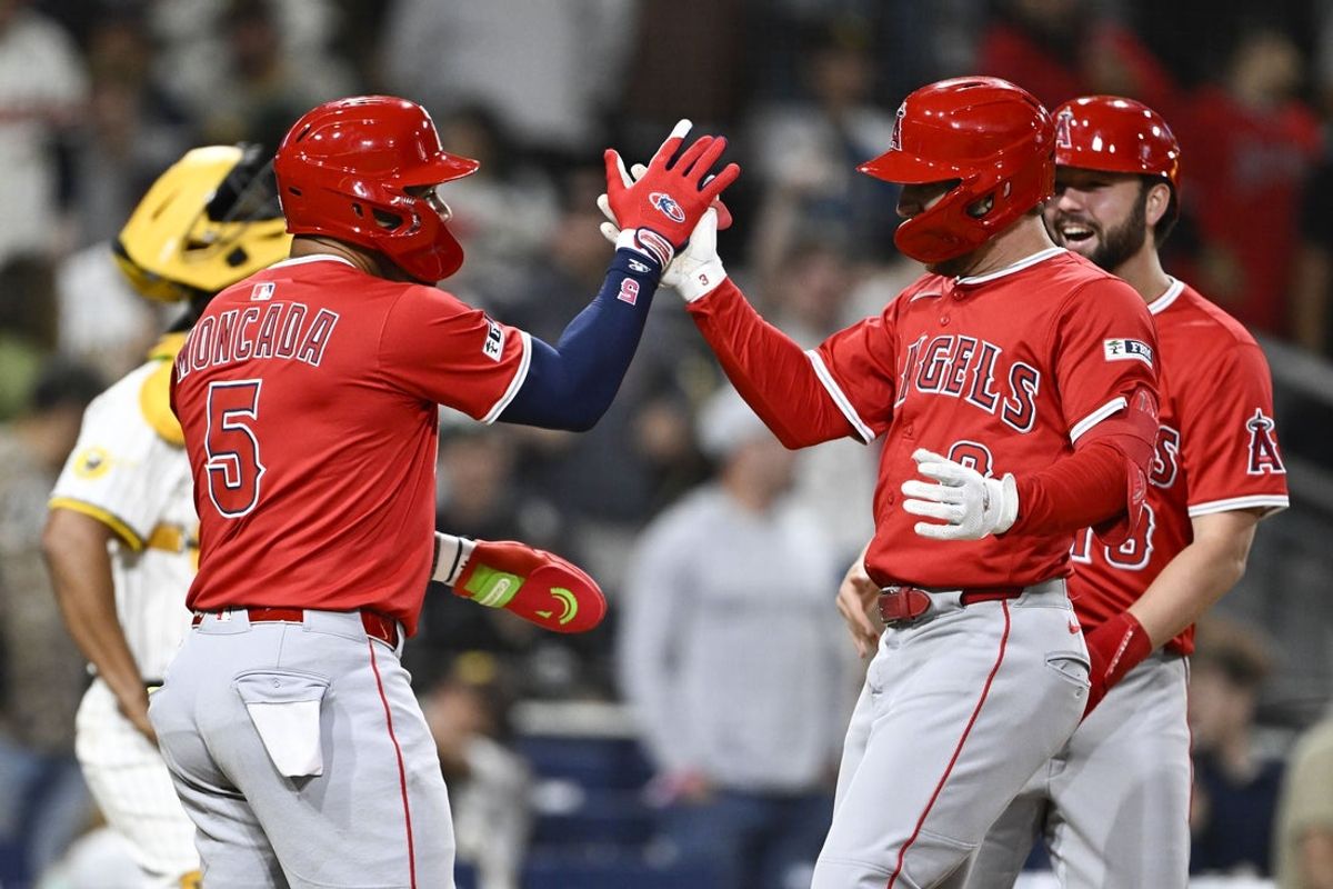 May 12, 2025; San Diego, California, USA; Los Angeles Angels left fielder Taylor Ward (3), right, is congratulated by Yoan Moncada (5) after hitting a grand slam during the ninth inning against the San Diego Padres at Petco Park. Mandatory Credit: Denis Poroy-Imagn Images