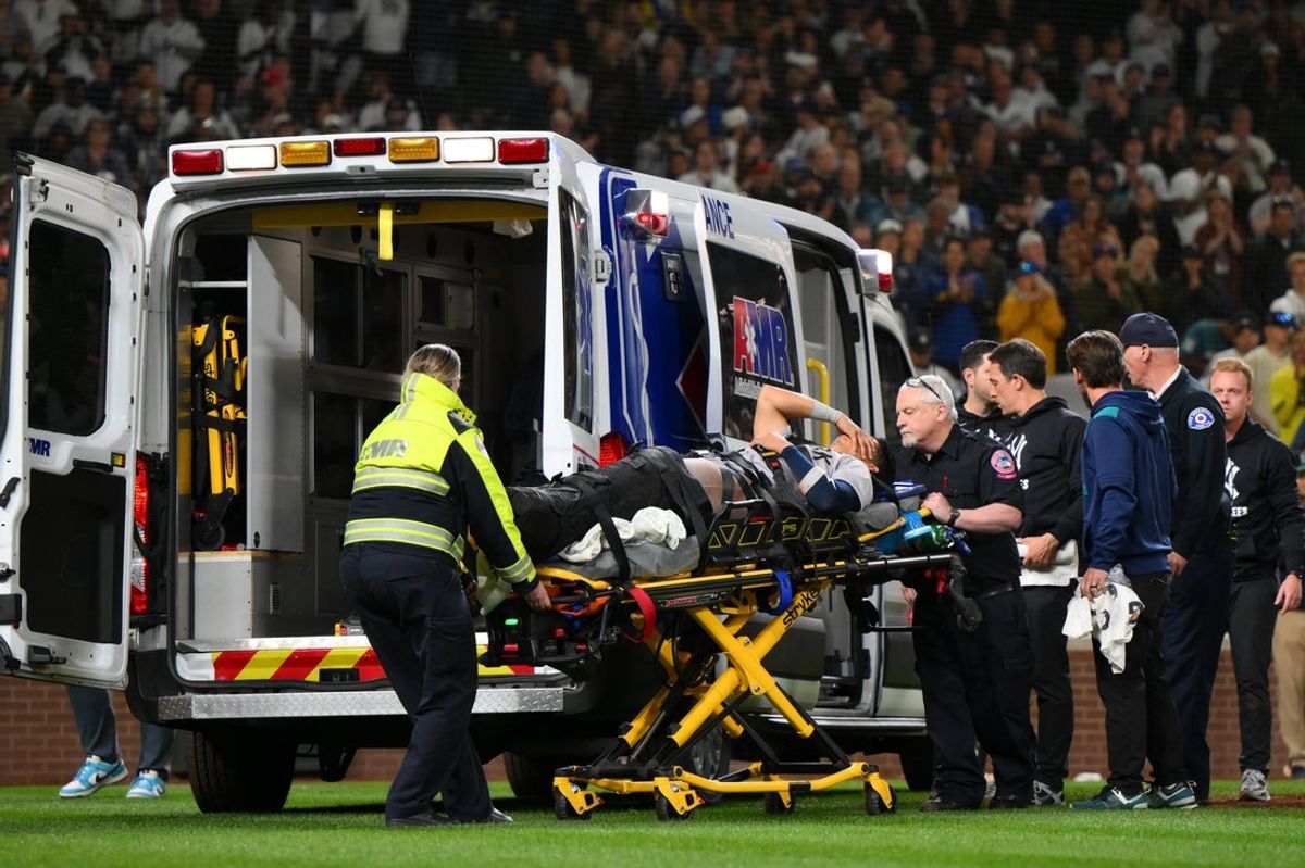 May 12, 2025; Seattle, Washington, USA; New York Yankees third baseman Oswaldo Cabrera (95) is loaded into an ambularnce after a leg injury while scoring a run against the Seattle Mariners during the eighth inning at T-Mobile Park. Mandatory Credit: Steven Bisig-Imagn Images