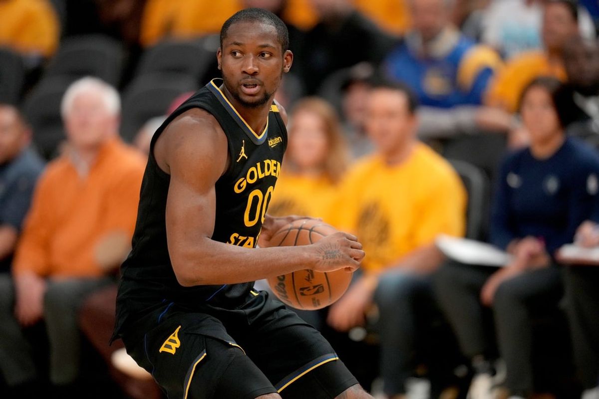 May 12, 2025; San Francisco, California, USA; Golden State Warriors forward Jonathan Kuminga (00) holds onto the ball against the Minnesota Timberwolves in the fourth quarter during game four of the second round for the 2025 NBA Playoffs at Chase Center. Mandatory Credit: Cary Edmondson-Imagn Images