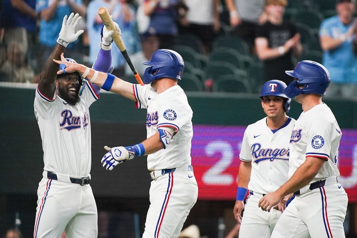 May 13, 2025; Arlington, Texas, USA; Texas Rangers third baseman Josh Jung (6) is greeted by outfielder Adolis García (53) after hitting a three-run home run scoring outfielder Sam Haggerty (0) and outfielder Evan Carter (32) during the first inning against the Colorado Rockies at Globe Life Field. Mandatory Credit: Raymond Carlin III-Imagn Images