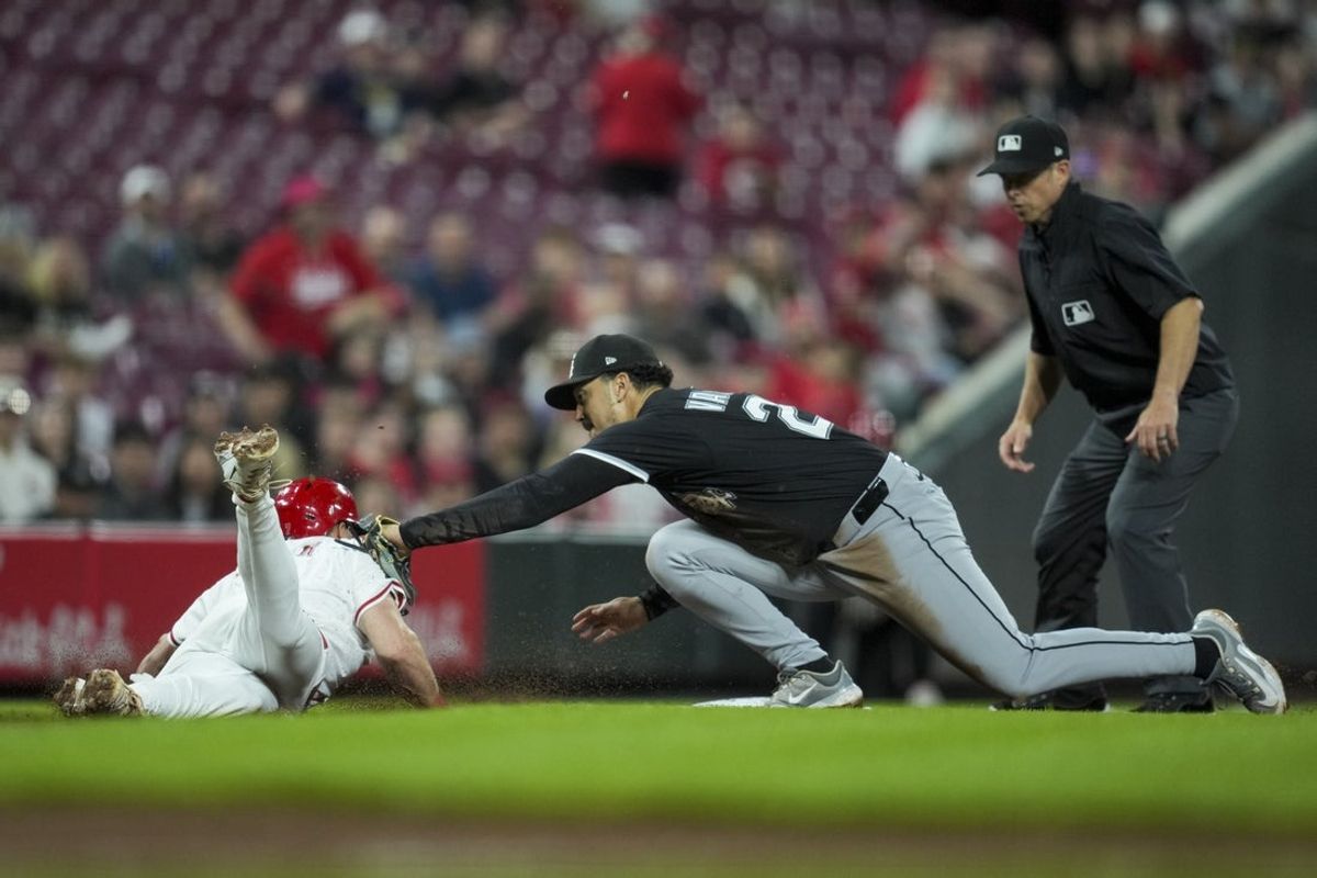 May 13, 2025; Cincinnati, Ohio, USA;  Cincinnati Reds first baseman Spencer Steer (7) is tagged out by Chicago White Sox third baseman Miguel Vargas (20) at third base in the fifth inning at Great American Ball Park. Mandatory Credit: Aaron Doster-Imagn Images