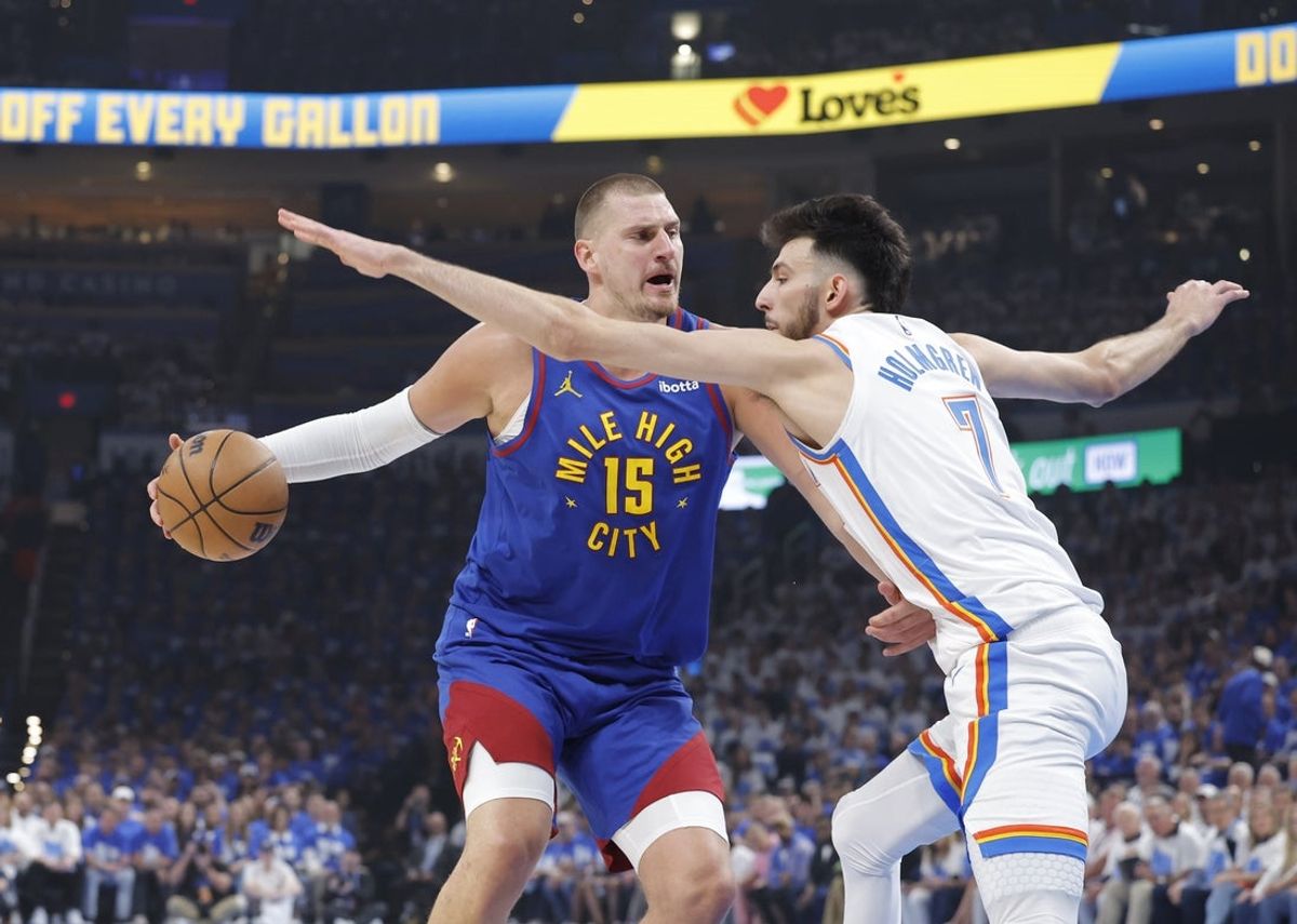 May 13, 2025; Oklahoma City, Oklahoma, USA; Denver Nuggets center Nikola Jokic (15) is defended by Oklahoma City Thunder forward Chet Holmgren (7) on a drive during the first quarter of game five of the second round for the 2025 NBA Playoffs at Paycom Center. Mandatory Credit: Alonzo Adams-Imagn Images