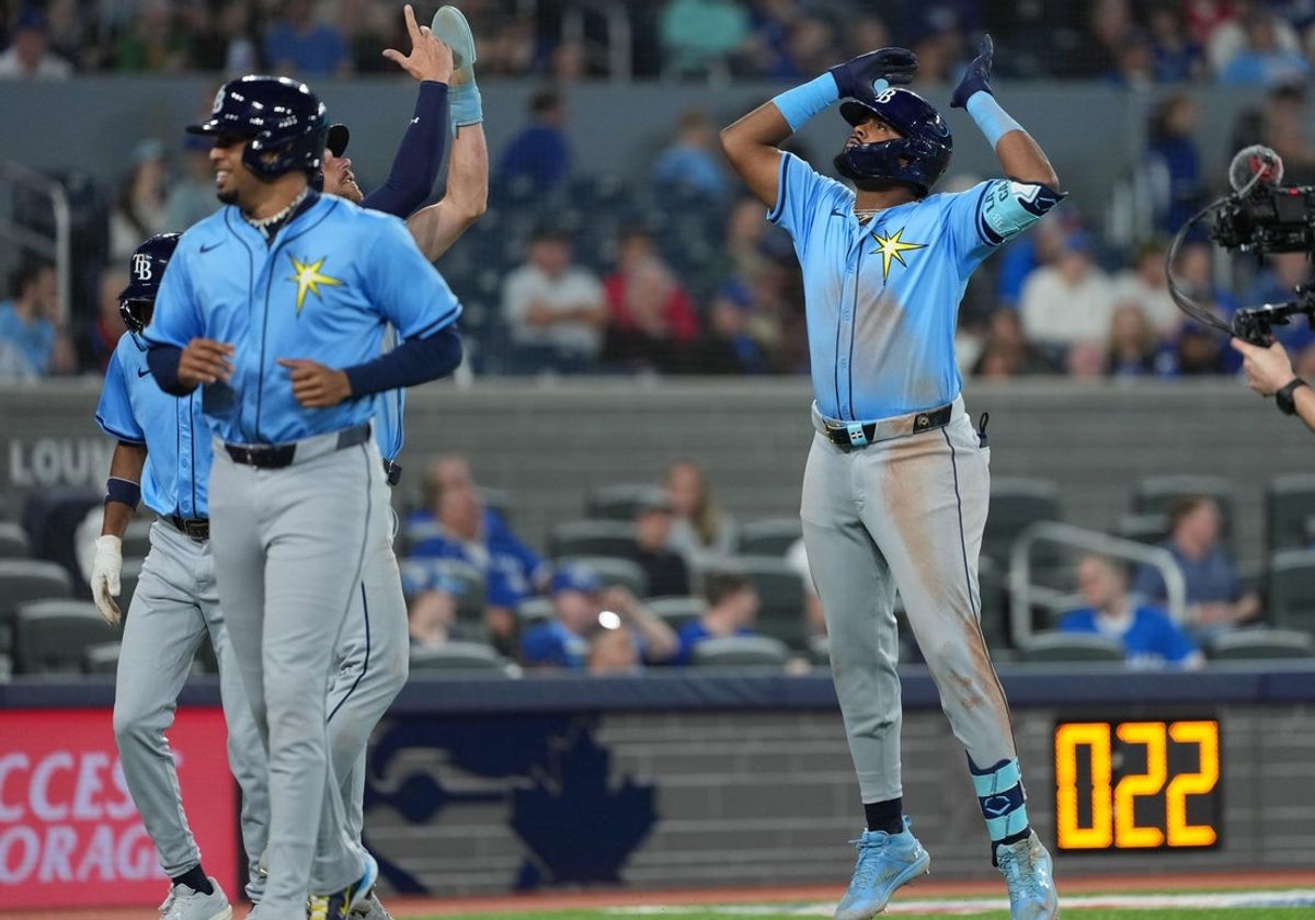 May 13, 2025; Toronto, Ontario, CAN; Tampa Bay Rays third baseman Junior Caminero (13) hits a grand slam home run and celebrates with designated hitter Brandon Lowe (8) against the Toronto Blue Jays during the ninth inning at Rogers Centre. Mandatory Credit: Nick Turchiaro-Imagn Images