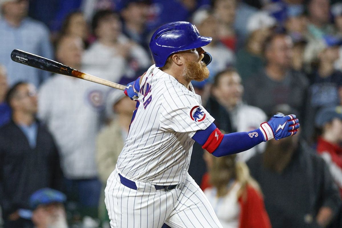 May 13, 2025; Chicago, Illinois, USA; Chicago Cubs first base Justin Turner (3) hits a walk-off two-run double against the Miami Marlins during the ninth inning at Wrigley Field. Mandatory Credit: Kamil Krzaczynski-Imagn Images