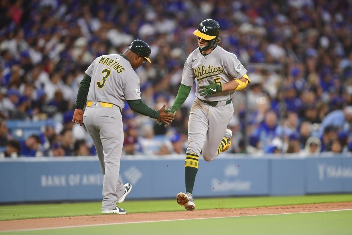 May 13, 2025; Los Angeles, California, USA; Oakland Athletics shortstop Jacob Wilson (5) rounds the bases after hitting a two run homerun in the second inning against the Los Angeles Dodgers at Dodger Stadium. Mandatory Credit: Gary A. Vasquez-Imagn Images