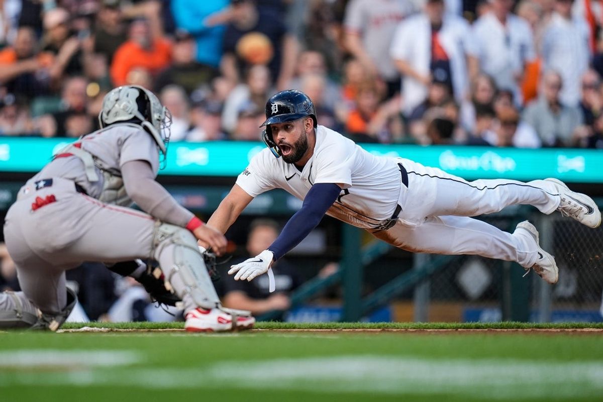 Detroit Tigers left fielder Riley Greene (31) dives for home base against Boston Red Sox catcher Carlos Narváez (75) during the second inning at Comerica Park in Detroit on Wednesday, May 14, 2025.