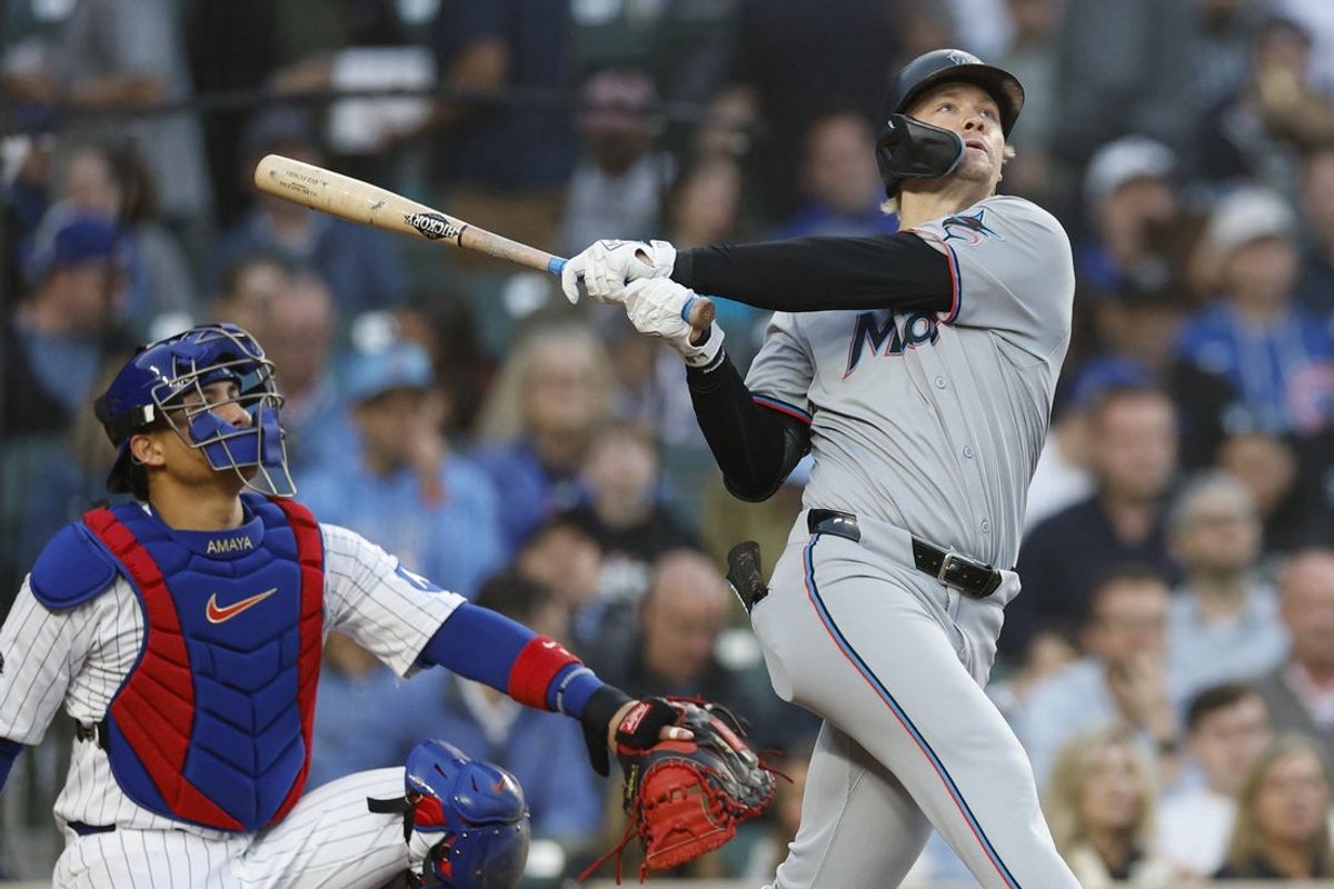 May 14, 2025; Chicago, Illinois, USA; Miami Marlins center fielder Kyle Stowers (28) hits a solo home run against the Chicago Cubs during the fourth inning at Wrigley Field. Mandatory Credit: Kamil Krzaczynski-Imagn Images