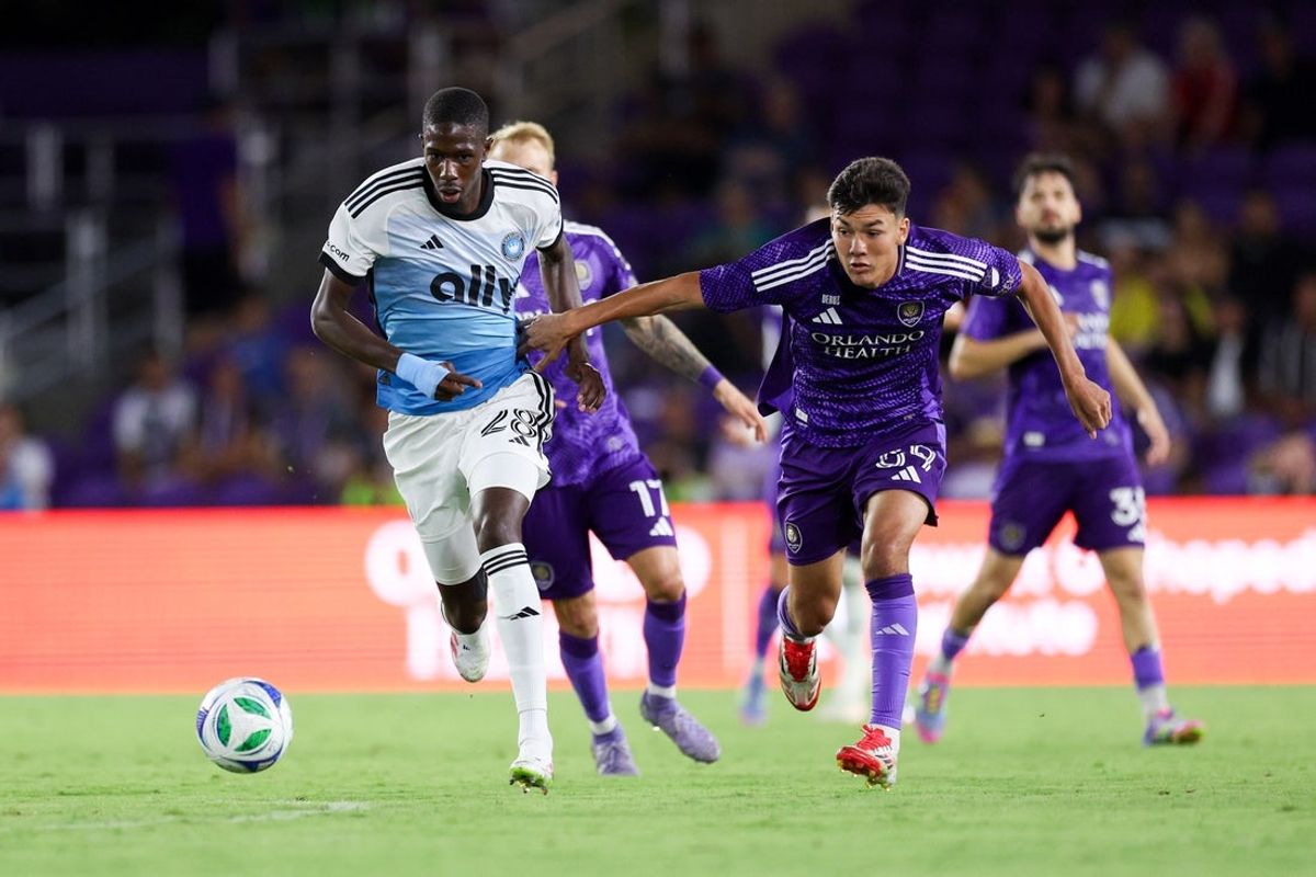 May 14, 2025; Orlando, Florida, USA; Orlando City forward Justin Ellis (59) and Charlotte FC midfielder Djibril Diani (28) battle for the ball in the second half at Inter&Co Stadium. Mandatory Credit: Nathan Ray Seebeck-Imagn Images
