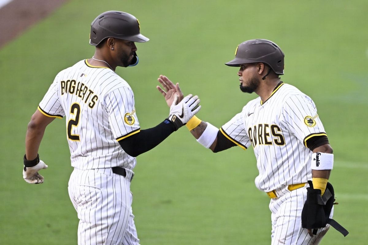 May 14, 2025; San Diego, California, USA; San Diego Padres shortstop Xander Bogaerts (2) is congratulated by Luis Arraez (4) after hitting three-run home run during the first inning against the Los Angeles Angels at Petco Park. Mandatory Credit: Denis Poroy-Imagn Images