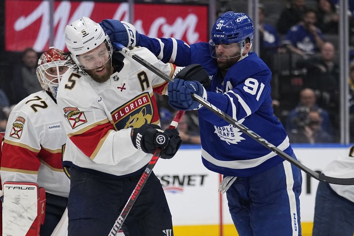 May 14, 2025; Toronto, Ontario, CAN; Toronto Maple Leafs forward John Tavares (91) checks Florida Panthers defenseman Aaron Ekblad (5) during the third period of game five of the second round of the 2025 Stanley Cup Playoffs at Scotiabank Arena. Mandatory Credit: John E. Sokolowski-Imagn Images