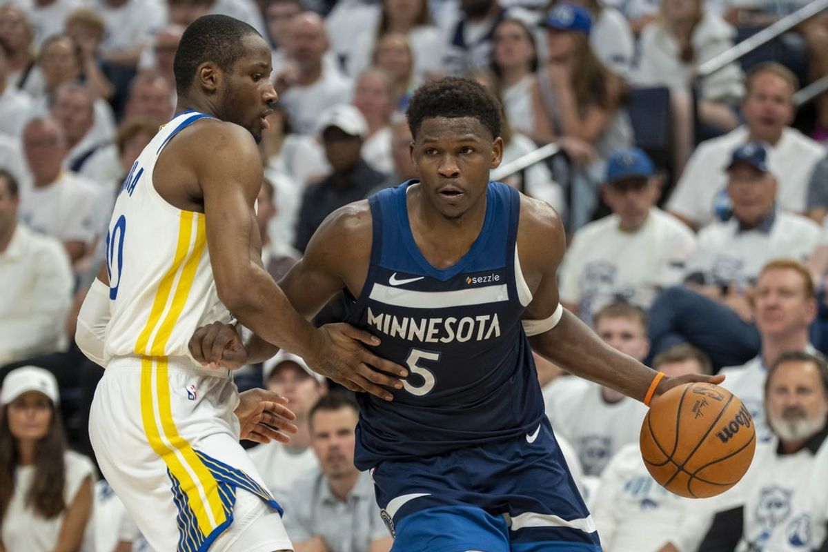 May 14, 2025; Minneapolis, Minnesota, USA; Minnesota Timberwolves guard Anthony Edwards (5) drives to the basket past Golden State Warriors forward Jonathan Kuminga (00) in the first half during game five of the second round for the 2025 NBA Playoffs at Target Center. Mandatory Credit: Jesse Johnson-Imagn Images