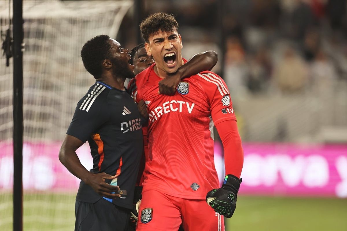 May 14, 2025; San Diego, California, USA; San Diego FC goalkeeper CJ dos Santos (1) reacts after blocking a penalty kick with defender William Kumado (2) during the second half against Colorado Rapids at Snapdragon Stadium. Mandatory Credit: Julia Kapros-Imagn Images