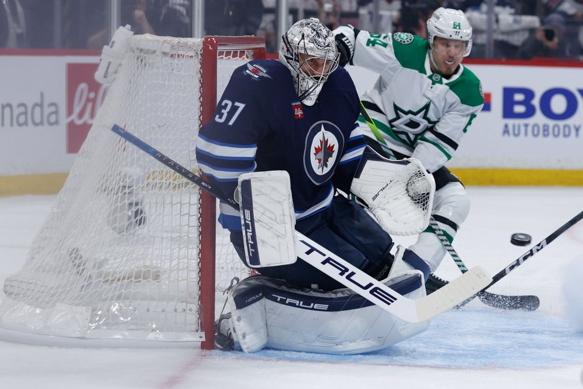 May 15, 2025; Winnipeg, Manitoba, CAN; Winnipeg Jets goalie Connor Hellebuyck (37) watches a Dallas Stars shot during the first period in game five of the second round of the 2025 Stanley Cup Playoffs at Canada Life Centre. Mandatory Credit: Terrence Lee-Imagn Images