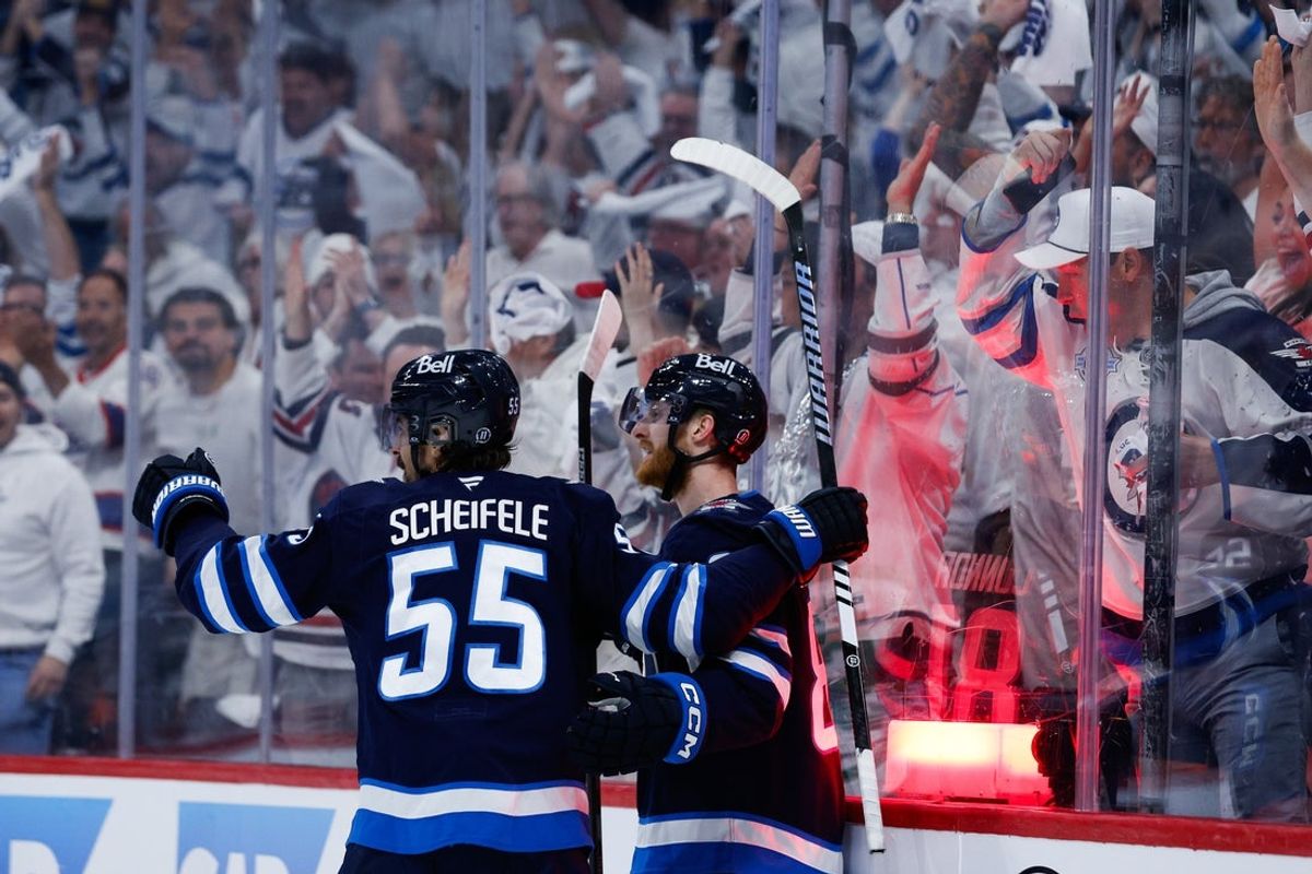 May 15, 2025; Winnipeg, Manitoba, CAN; Winnipeg Jets forward Mark Scheifele (55) is congratulated by Winnipeg Jets forward Kyle Connor (81) on his goal against the Dallas Stars during the second period in game five of the second round of the 2025 Stanley Cup Playoffs at Canada Life Centre. Mandatory Credit: Terrence Lee-Imagn Images