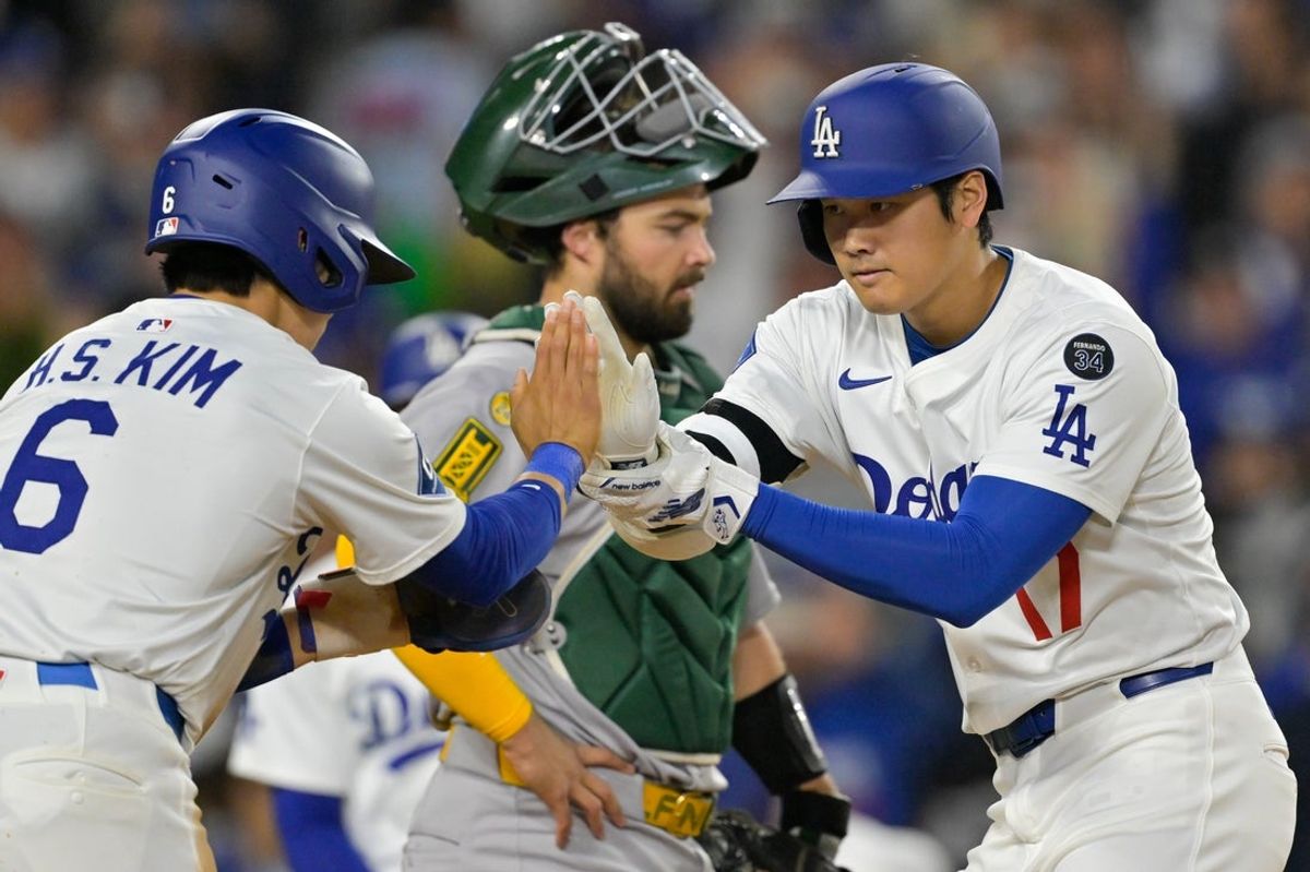 May 15, 2025; Los Angeles, California, USA; Los Angeles Dodgers designated hitter Shohei Ohtani (17) celebrates after hitting a two-run home run against the Athletics wiht second baseman Hyeseong Kim (6) during the fourth inning of the game at Dodger Stadium. Mandatory Credit: Jayne Kamin-Oncea-Imagn Images