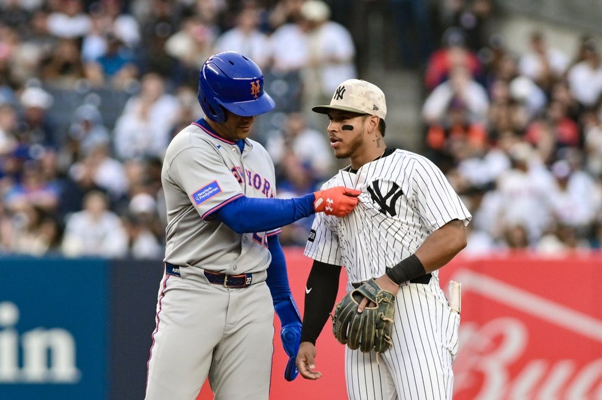 May 16, 2025; Bronx, New York, USA; New York Mets outfielder Juan Soto (22) interacts with New York Yankees second baseman Jorbit Vivas (90) during the first inning at Yankee Stadium. Mandatory Credit: John Jones-Imagn Images