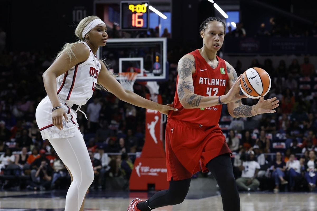 May 16, 2025; Washington, District of Columbia, USA; Atlanta Dream center Brittney Griner (42) passes the ball as Washington Mystics forward Kiki Iriafen (44) defends in the first half at CareFirst Arena. Mandatory Credit: Geoff Burke-Imagn Images