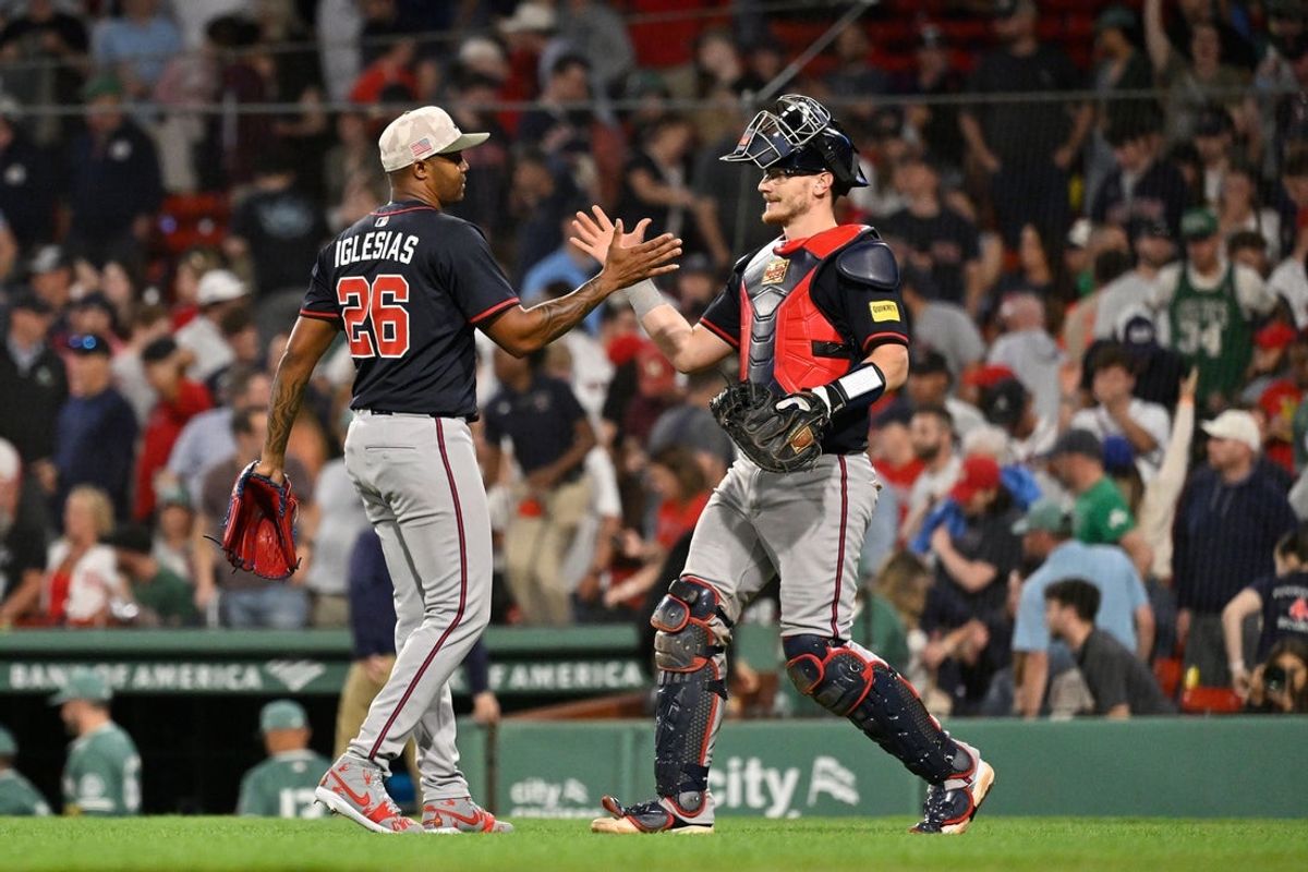 May 16, 2025; Boston, Massachusetts, USA; Atlanta Braves relief pitcher Raisel Iglesias (26) and catcher Sean Murphy (12) celebrate defeating the Boston Red Sox at Fenway Park. Mandatory Credit: Eric Canha-Imagn Images
