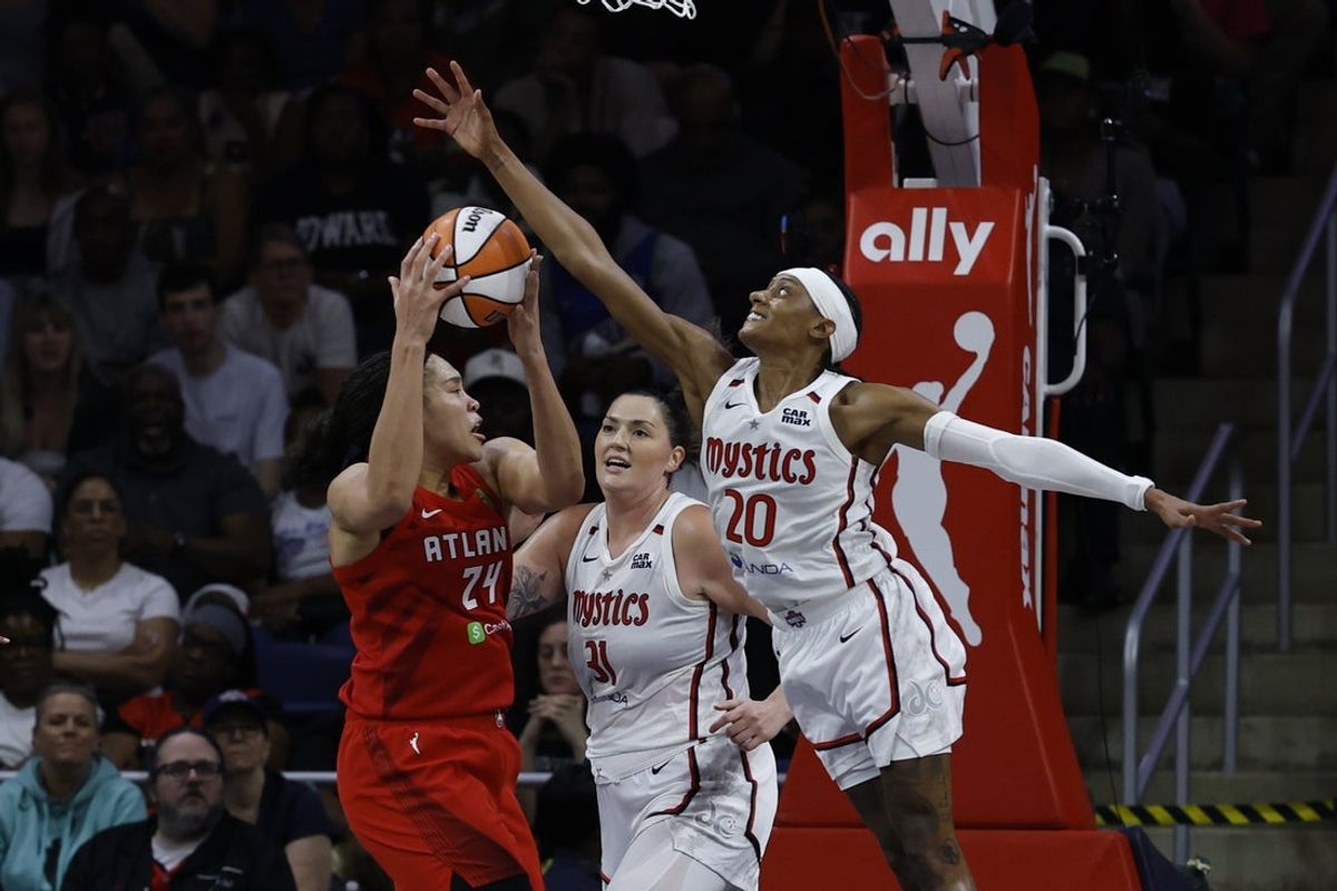 May 16, 2025; Washington, District of Columbia, USA; Atlanta Dream forward Brionna Jones (24) drives to the basket as Washington Mystics guard Brittney Sykes (20) defends in the first half at CareFirst Arena. Mandatory Credit: Geoff Burke-Imagn Images
