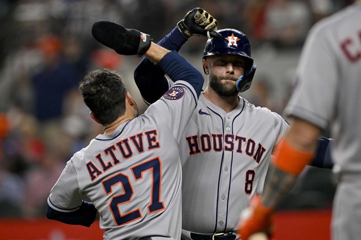 May 16, 2025; Arlington, Texas, USA; Houston Astros first baseman Christian Walker (8) and second baseman Jose Altuve (27) celebrate after Walker hits a three run home run against the Texas Rangers during the seventh inning at Globe Life Field. Mandatory Credit: Jerome Miron-Imagn Images
