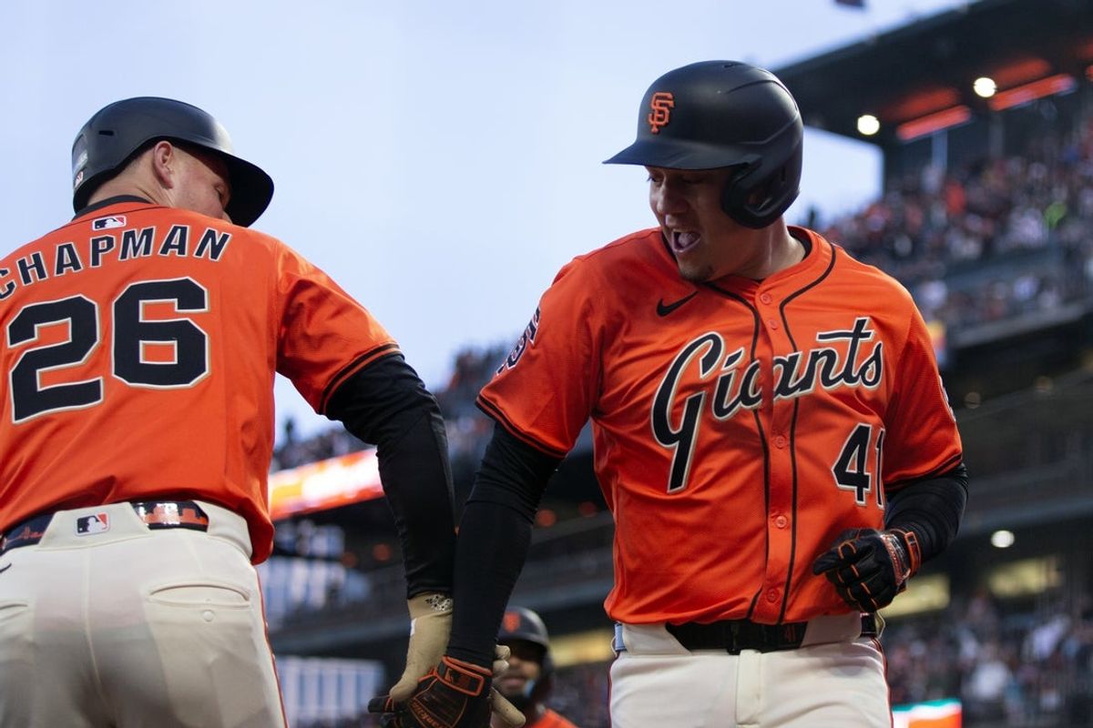 May 16, 2025; San Francisco, California, USA; San Francisco Giants first baseman Wilmer Flores (41) is greeted by his teammates after hitting a grand slam against the Athletics during the third inning at Oracle Park. Mandatory Credit: D. Ross Cameron-Imagn Images