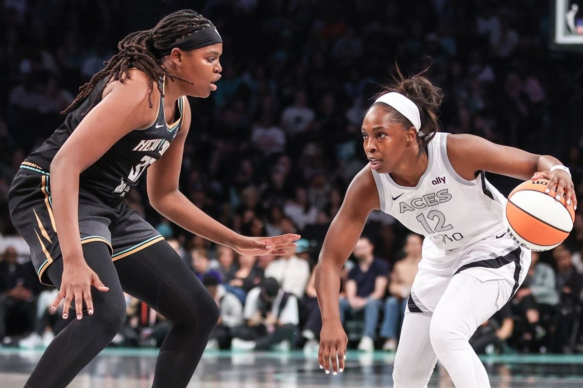 May 17, 2025; Brooklyn, New York, USA;  Las Vegas Aces guard Chelsea Gray (12) looks to drive past New York Liberty center Jonquel Jones (35) in the second quarter at Barclays Center. Mandatory Credit: Wendell Cruz-Imagn Images