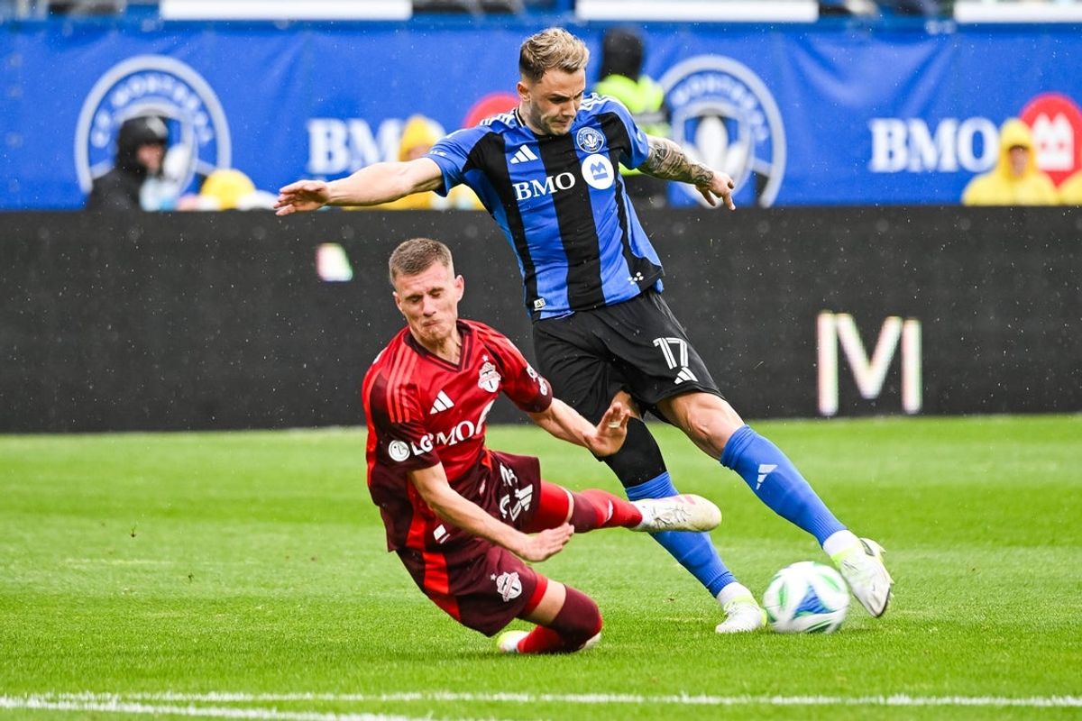 May 17, 2025; Montreal, Province of Quebec, CAN; Toronto FC midfielder Maxime Dominguez (23) attempts to tackle CF Montreal forward Giacomo Vrioni (17) during the first half at Saputo Stadium. Mandatory Credit: David Kirouac-Imagn Images