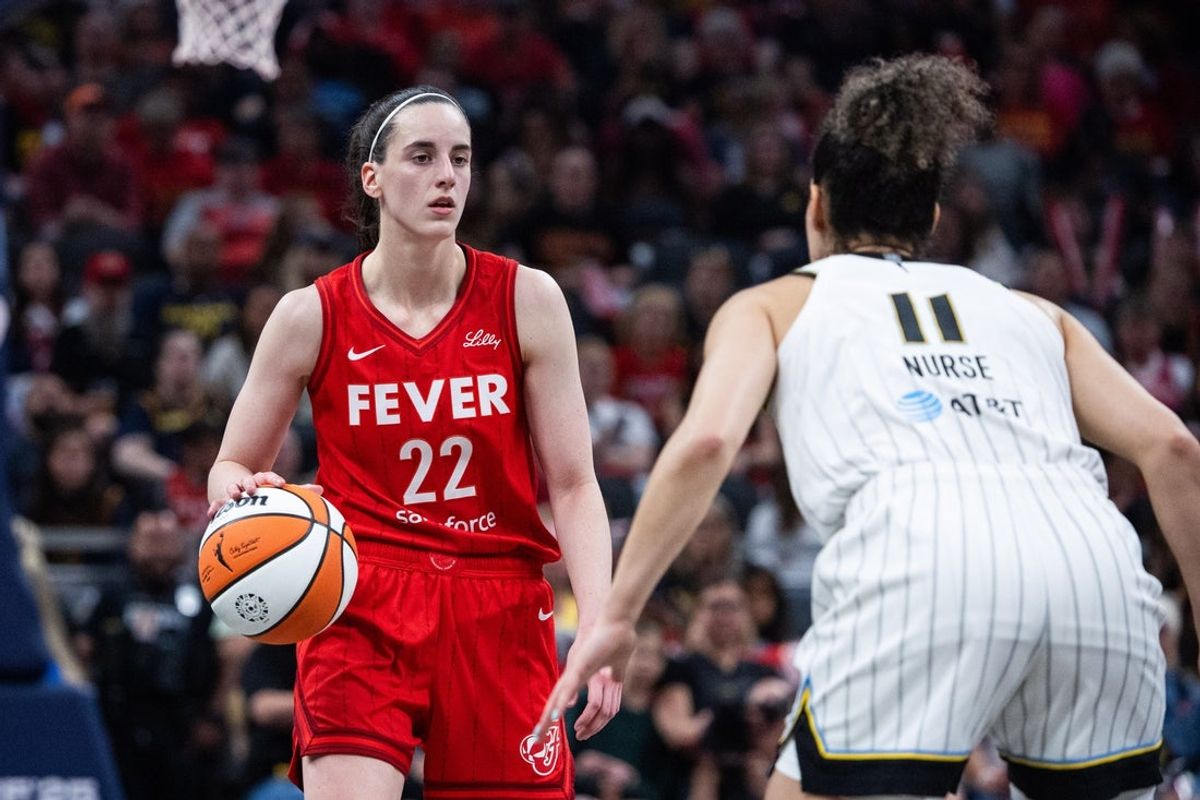 May 17, 2025; Indianapolis, Indiana, USA; Indiana Fever guard Caitlin Clark (22) dribbles  the ball while Chicago Sky guard Kia Nurse (11) defends in the first half at Gainbridge Fieldhouse. Mandatory Credit: Trevor Ruszkowski-Imagn Images