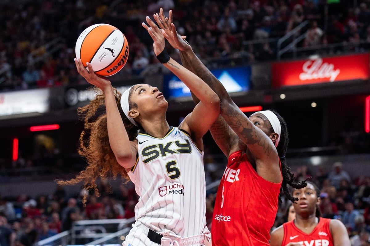 May 17, 2025; Indianapolis, Indiana, USA; Chicago Sky forward Angel Reese (5) shoots the ball while Indiana Fever forward Natasha Howard (6) defends in the second half at Gainbridge Fieldhouse. Mandatory Credit: Trevor Ruszkowski-Imagn Images