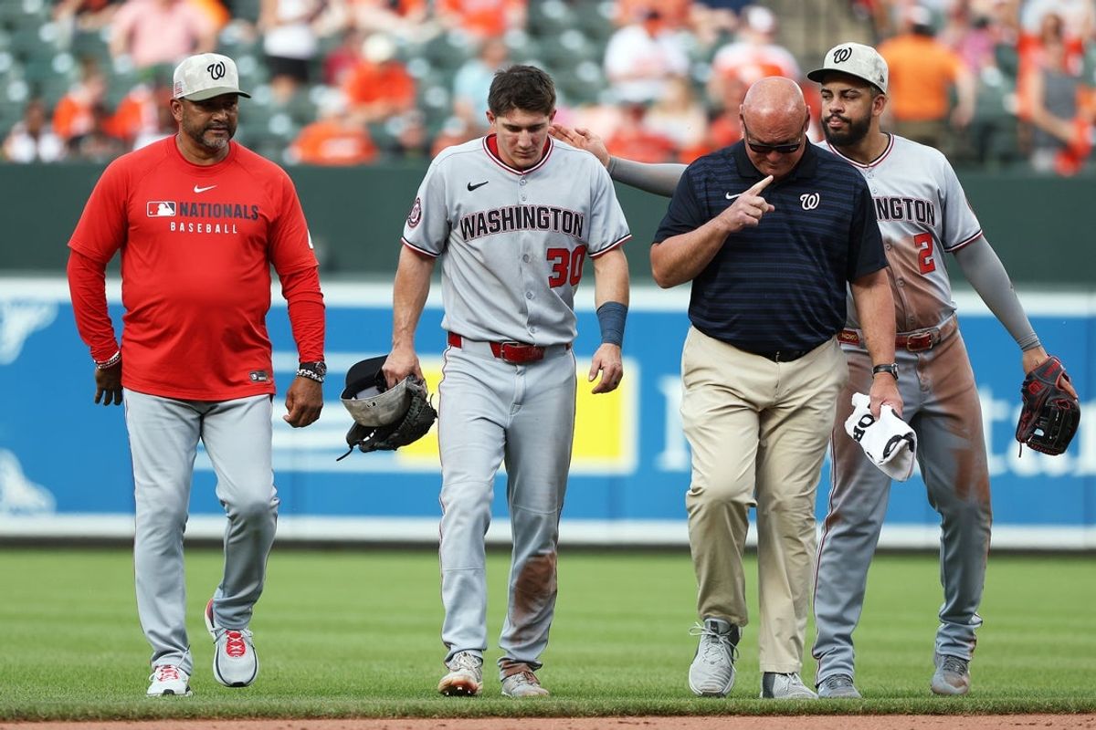 May 17, 2025; Baltimore, Maryland, USA; Washington Nationals outfielder Jacob Young (30) gets helped off of the field after getting injured during the seventh inning against the Baltimore Orioles at Oriole Park at Camden Yards. Mandatory Credit: Daniel Kucin Jr.-Imagn Images