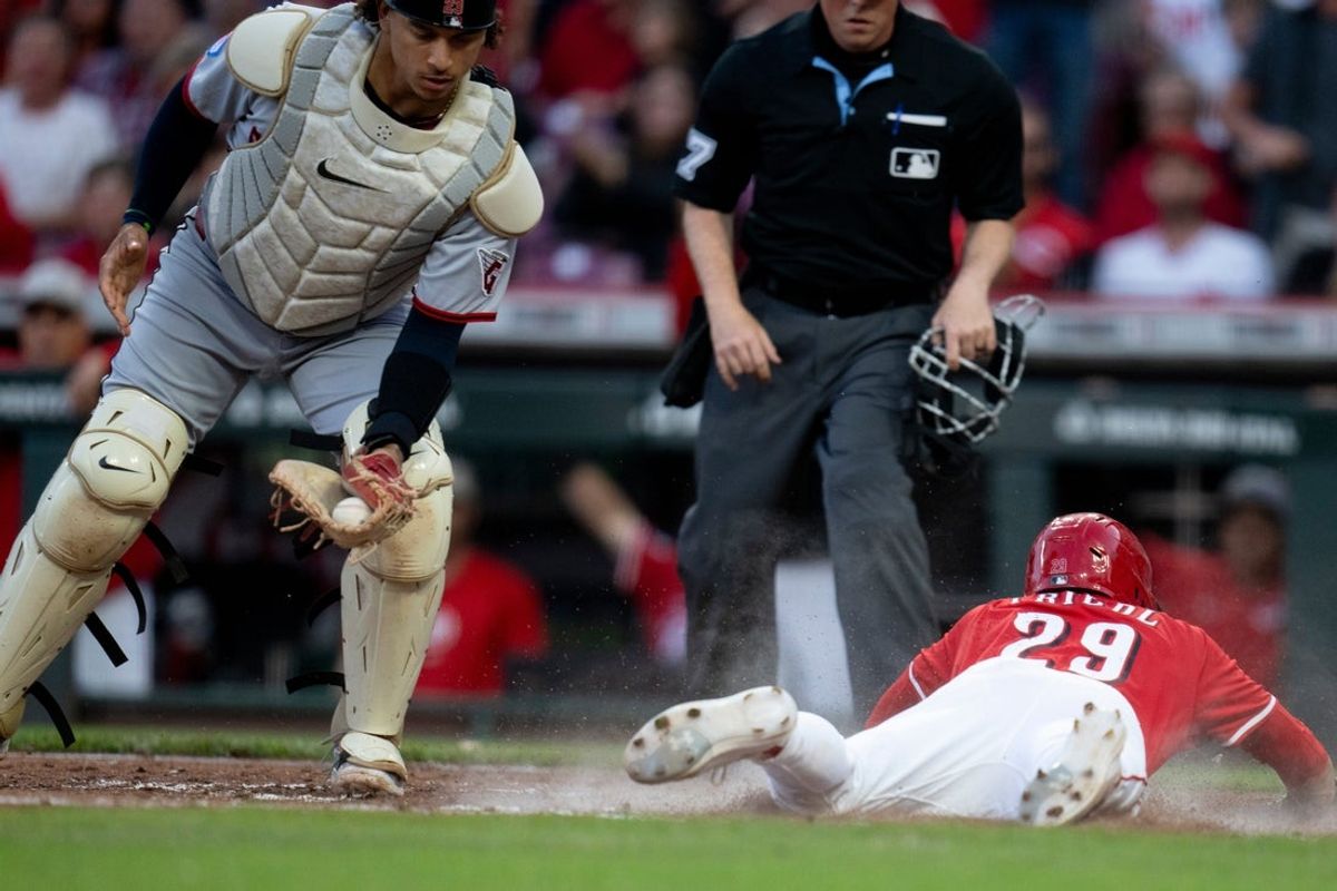 Cincinnati Reds outfielder TJ Friedl (29) scores off of a Cincinnati Reds third baseman Santiago Espinal (4) base hit as Cleveland Guardians catcher Bo Naylor (23) receives the throw from the outfield in the sixth inning of the MLB game between Cincinnati Reds and Cleveland Guardians at Great American Ball Park in Cincinnati on Saturday, May 17, 2025.