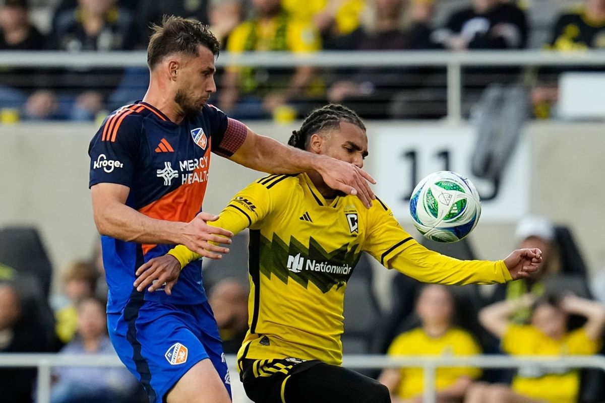 FC Cincinnati midfielder Pavel Bucha (20) collides with Columbus Crew defender Mohamed Farsi (23) during the first half of the MLS soccer match at Lower.com Field in Columbus on May 17, 2025.