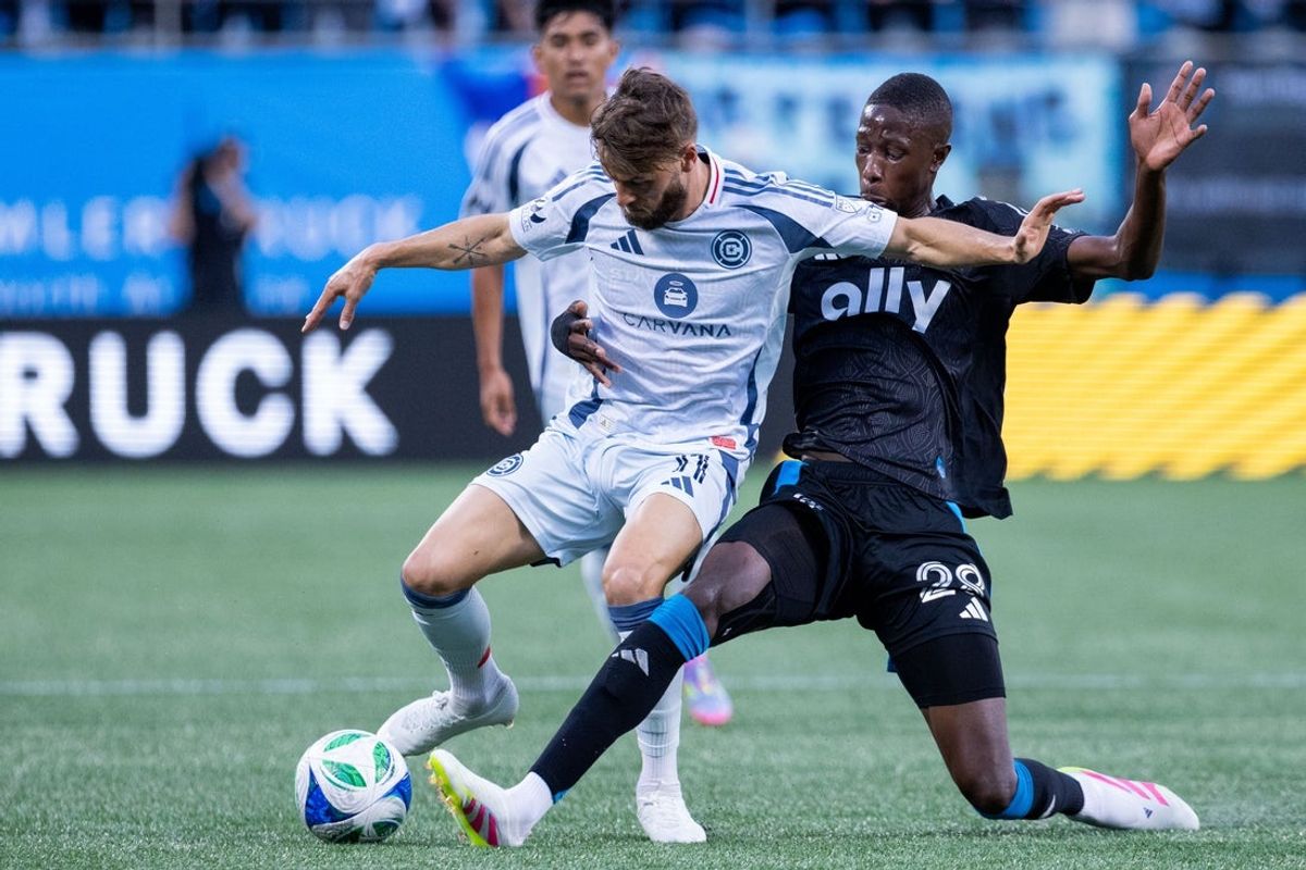 May 17, 2025; Charlotte, North Carolina, USA; Charlotte FC midfielder Djibril Diani (28) knocks the ball away from Chicago Fire forward Philip Zinckernagel (11) during the first half at Bank of America Stadium. Mandatory Credit: Scott Kinser-Imagn Images