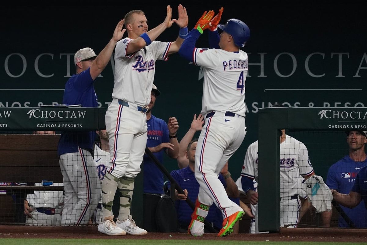 May 17, 2025; Arlington, Texas, USA; Texas Rangers first baseman Joc Pederson (4) is greeted by third baseman Josh Jung (6) after hitting a two-run home run sixth inning against the Houston Astros at Globe Life Field. Mandatory Credit: Raymond Carlin III-Imagn Images