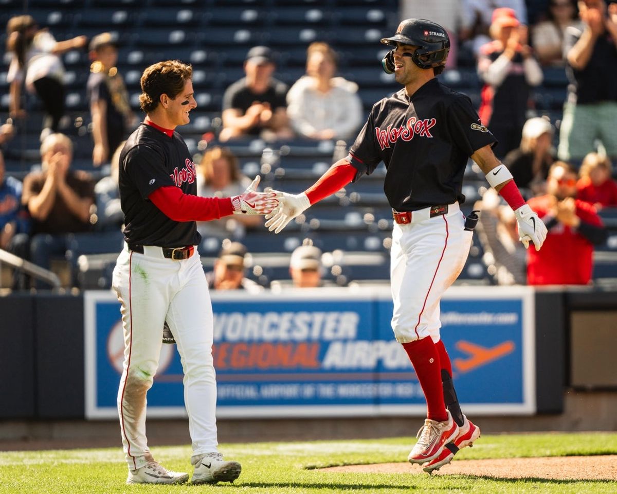 WooSox player Roman Anthony (left) high fives teammate Marcelo Mayer during a Triple-A game at Polar Park on April 23, 2025.