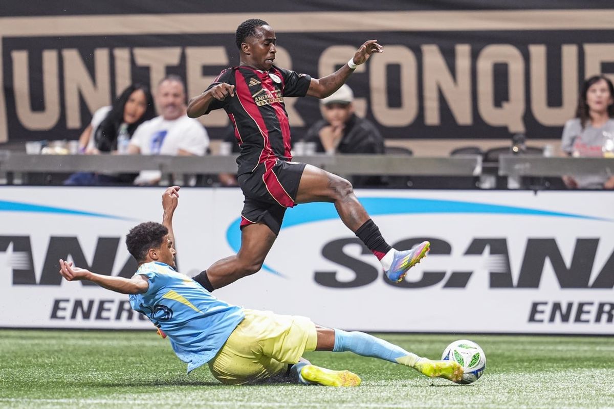 May 17, 2025; Atlanta, Georgia, USA; Atlanta United midfielder Edwin Mosquera (70) jumps over Philadelphia Union defender Nathan Harriel (26) during the second half at Mercedes-Benz Stadium. Mandatory Credit: Dale Zanine-Imagn Images