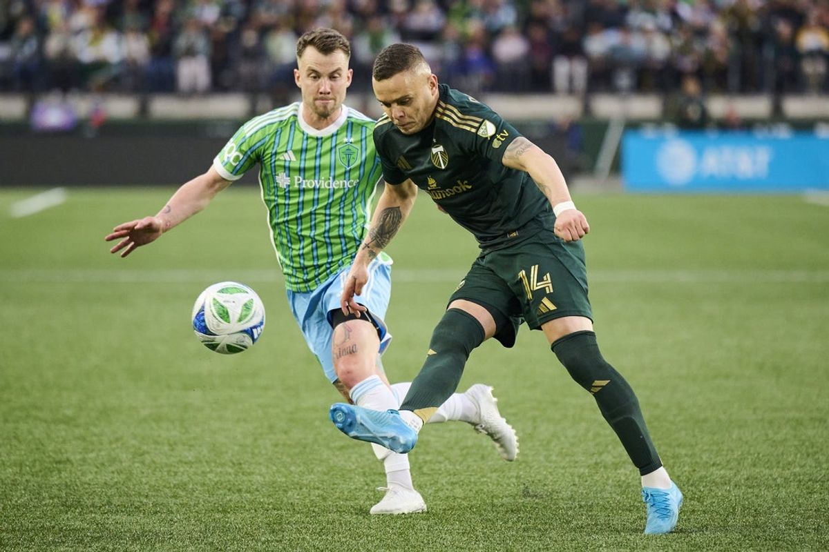 May 17, 2025; Portland, Oregon, USA; Portland Timbers forward Jonathan Rodriguez (14) passes the ball during the second half against Seattle Sounders midfielder Albert Rusnak (11) at Providence Park. Mandatory Credit: Troy Wayrynen-Imagn Images