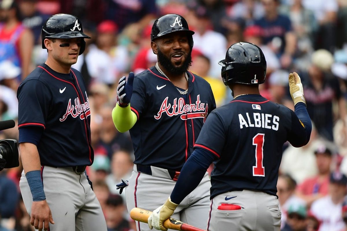 May 18, 2025; Boston, Massachusetts, USA;  Atlanta Braves designated hitter Marcell Ozuna (20) is congratulated by second baseman Ozzie Albies (1) after hitting a three run home run during the eighth inning against the Boston Red Sox at Fenway Park. Mandatory Credit: Bob DeChiara-Imagn Images