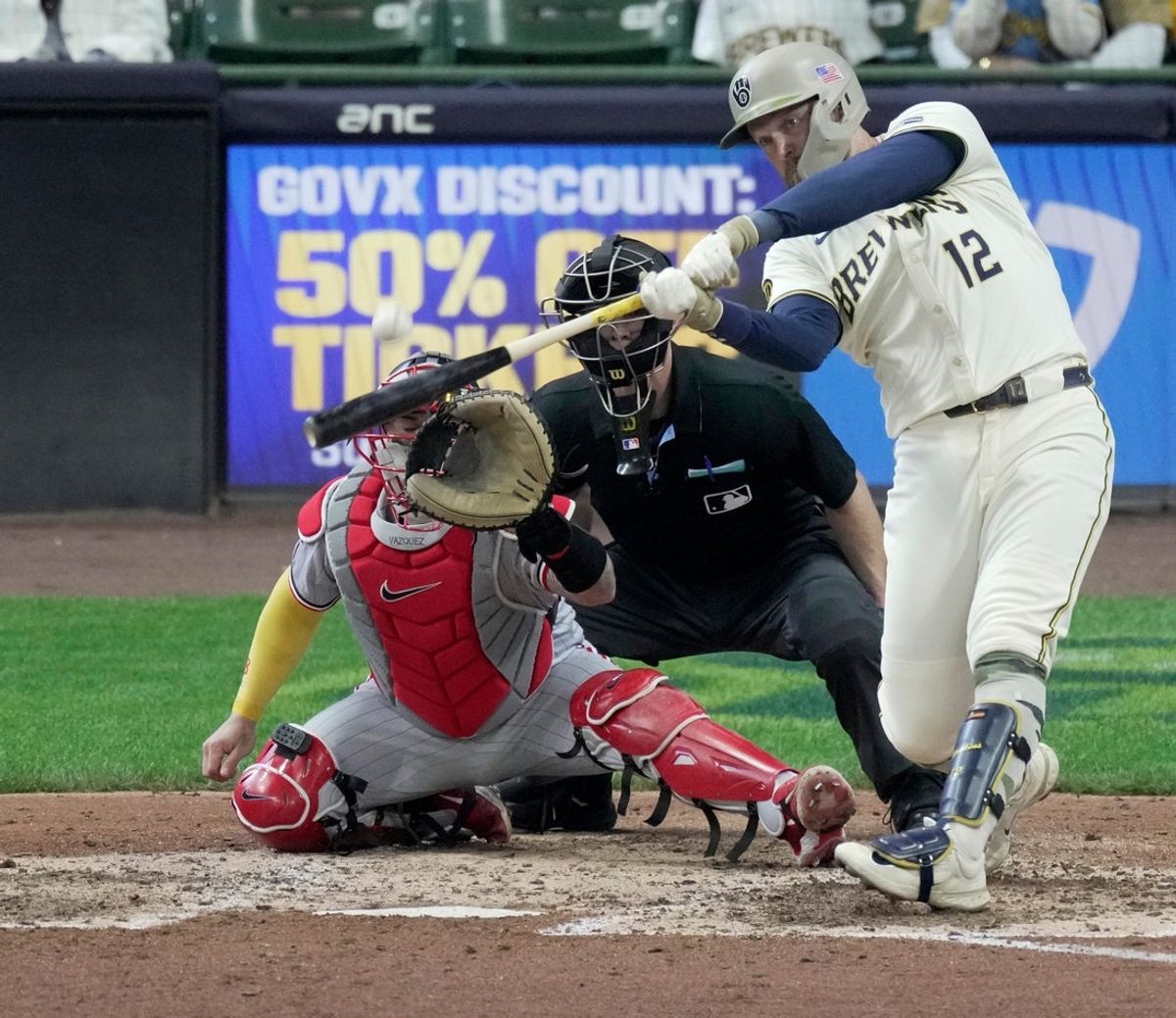 Milwaukee Brewers first baseman Rhys Hoskins (12) hits a sacrifice fly during the eighth inning of their game against the Minnesota Twins Sunday, May 18, 2025 at American Family Field in Milwaukee, Wisconsin.