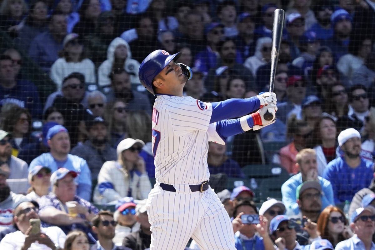 May 18, 2025; Chicago, Illinois, USA; Chicago Cubs outfielder Seiya Suzuki (27) hits a one run sacrifice fly against the Chicago White Sox during the sixth inning at Wrigley Field. Mandatory Credit: David Banks-Imagn Images